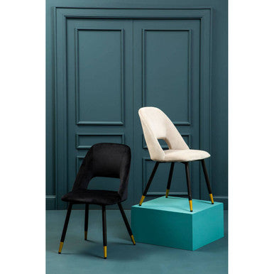 Warren black velvet dining chair with black and cream upholstery and gold legs one on turquoise pedestal