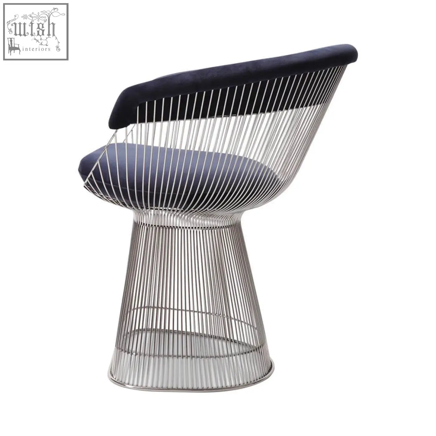 A sleek warren platner dining chair with polished chrome wireframe and plush navy blue velvet upholstery on seat and backrest