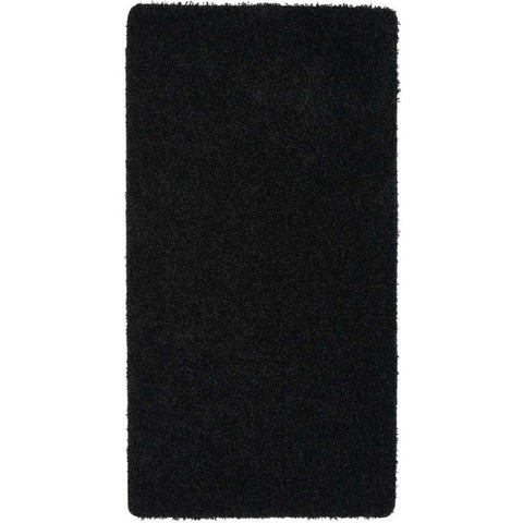 Washable black shaggy rug with plush textured surface and slightly frayed edges for cozy decor