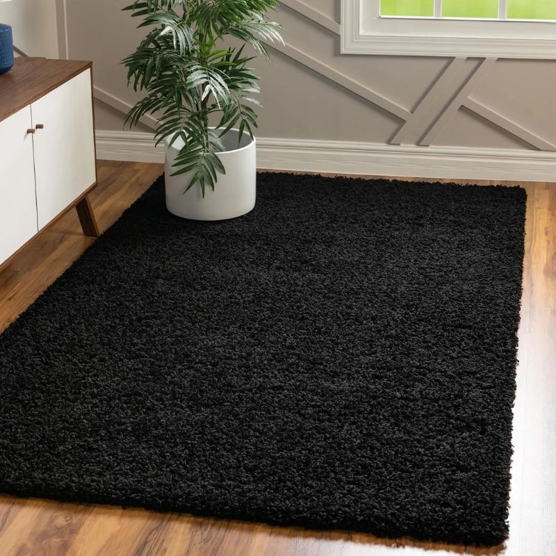 Washable black shaggy rug with plush textured surface perfect for cozy living space and easy cleaning