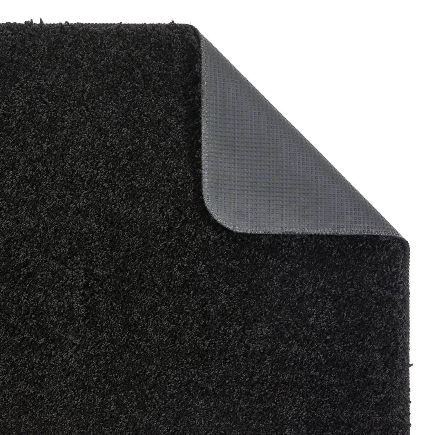 Washable black shaggy rug showing black textured carpet with durable rubber backing for non-slip use
