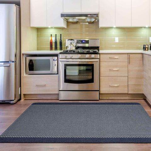 Dark gray washable bordered blue rug with subtle herringbone pattern and light gray border for easy cleaning
