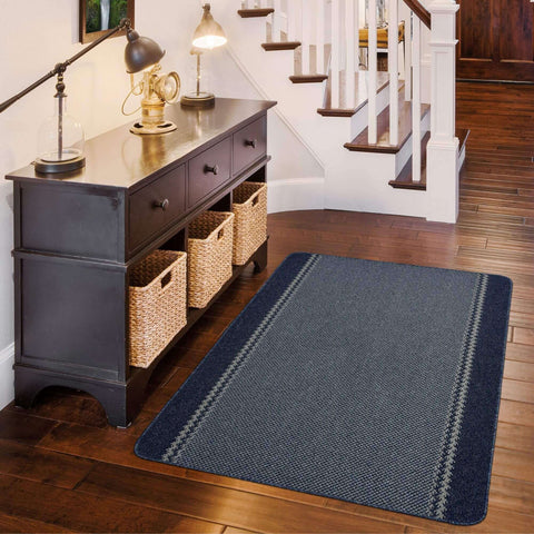 Navy blue washable bordered blue rug with textured surface and subtle gray border stripes perfect for any room