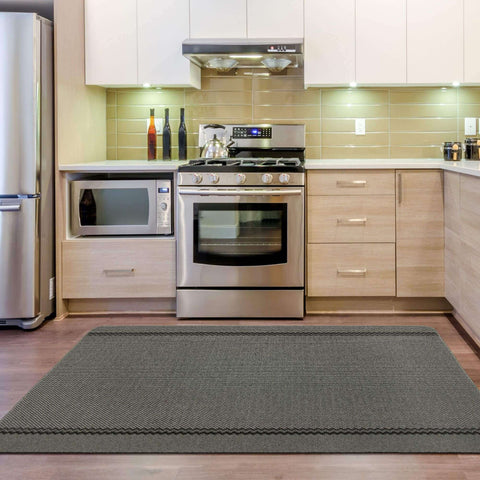 Gray textured kitchen rug with subtle herringbone pattern and decorative zigzag border washable bordered dark grey