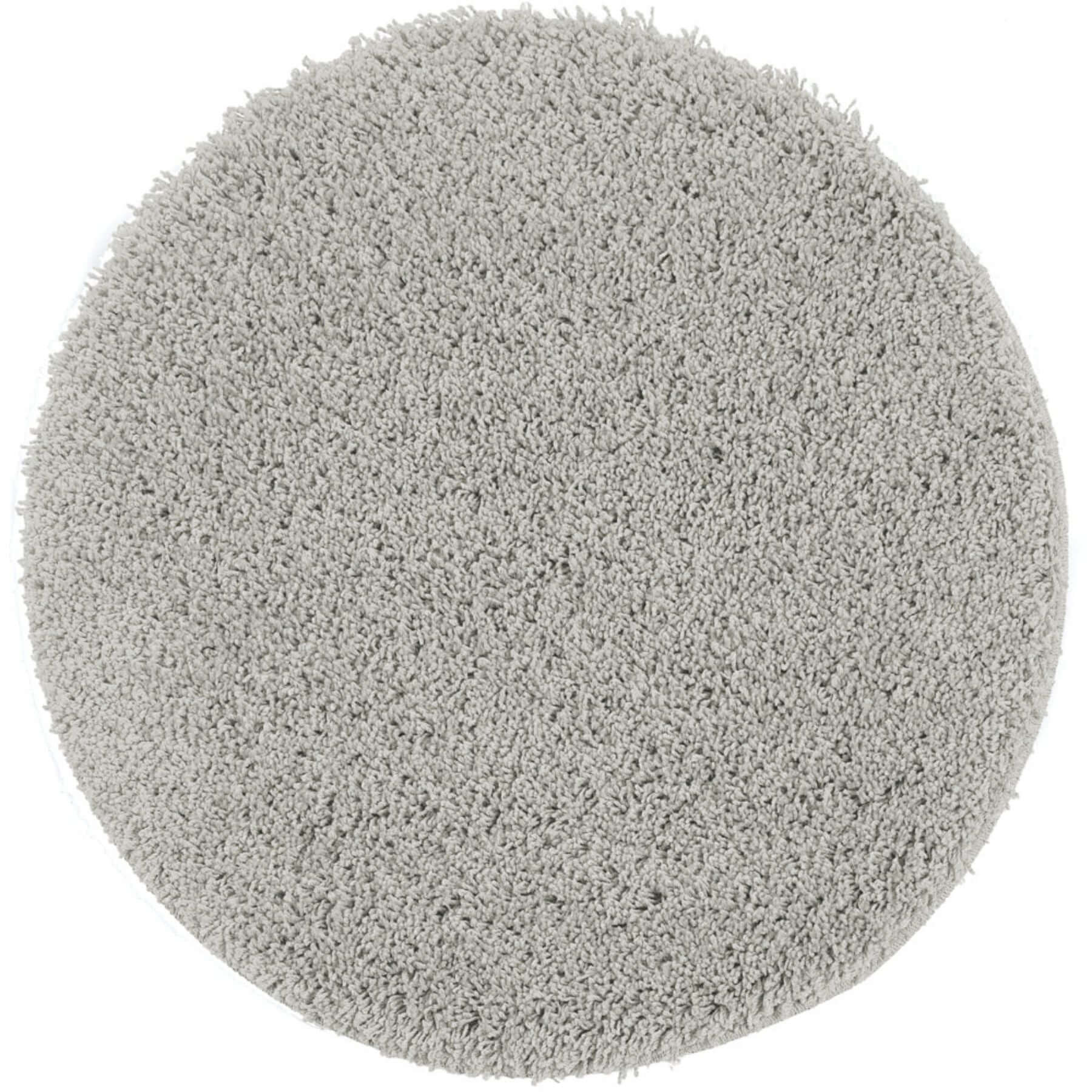 A plush round grey shaggy rug with a soft textured surface in washable ghost grey color