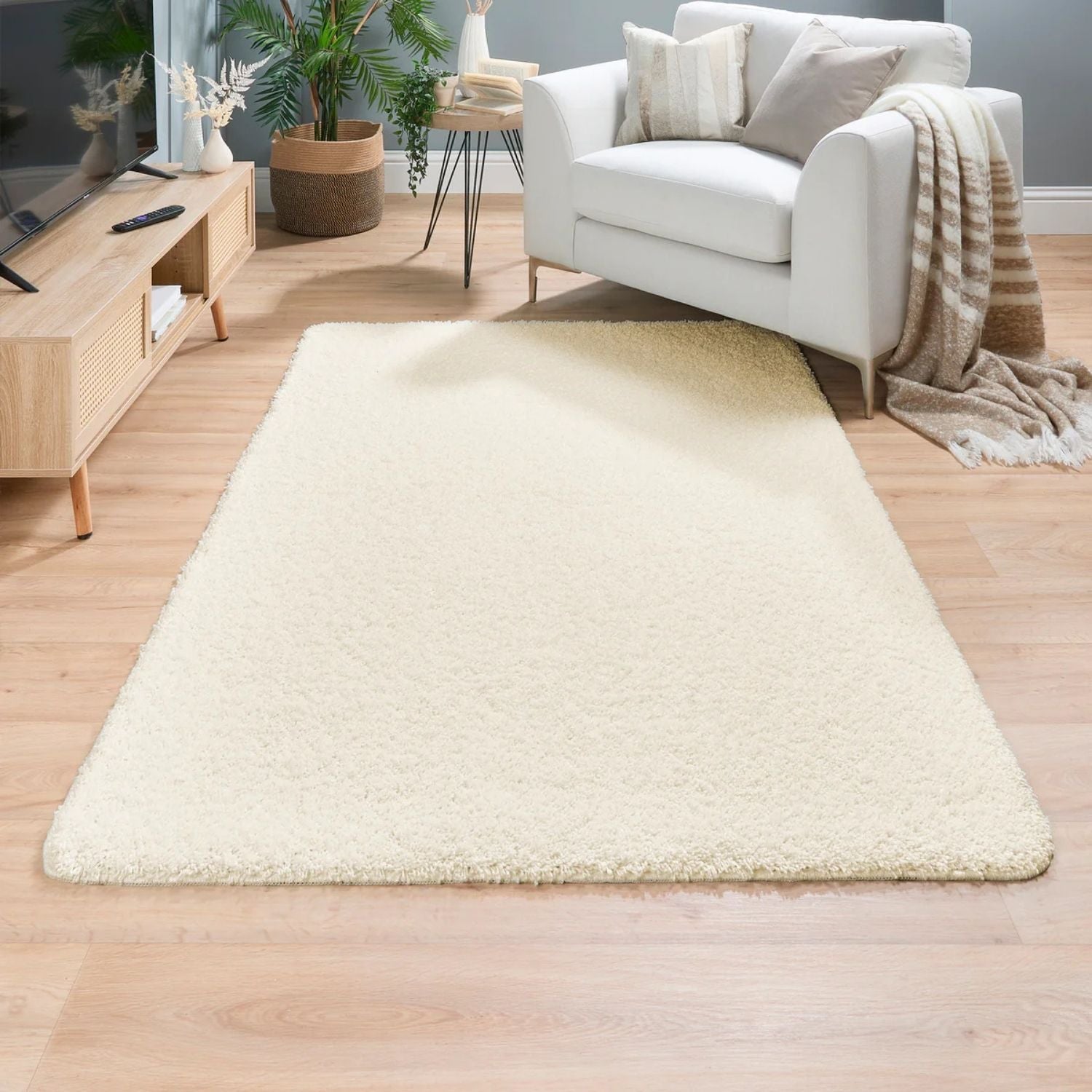 Cream-colored washable ghost ivory shaggy rug with plush fluffy texture and slightly frayed edges