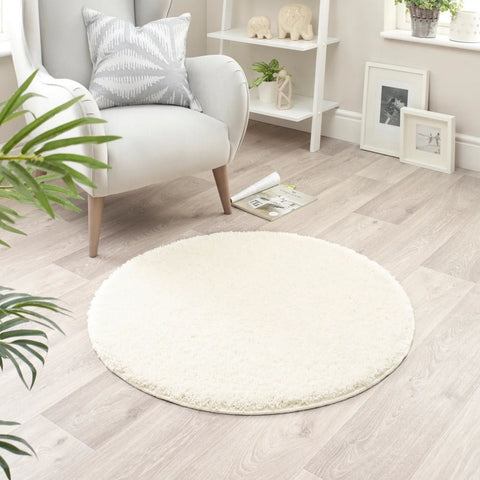 Cream-colored washable ghost ivory shaggy rug with plush circular design and soft frayed edges