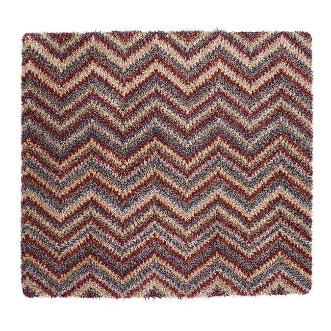 A plush washable mat with a bold chevron design in maroon beige and gray perfect for any room