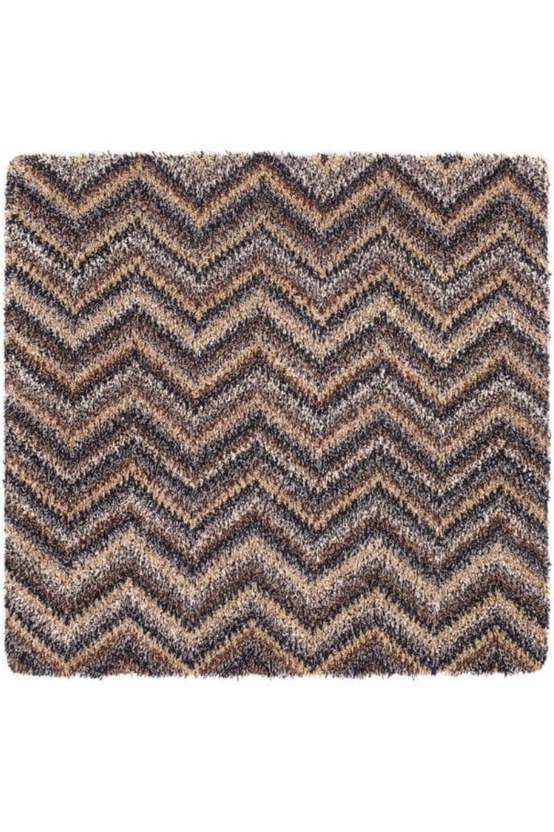 A washable mat with chevron design featuring bold brown and beige zigzag patterns on a shaggy rectangular rug