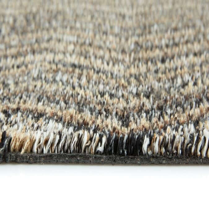 Beige and black textured washable mat with chevron design and fringed edge for easy cleaning and style