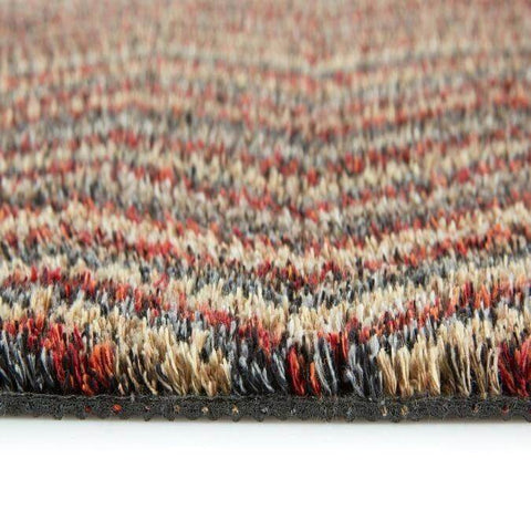 Multicolored washable mat with chevron design featuring red beige black and gray woven fibers textured surface
