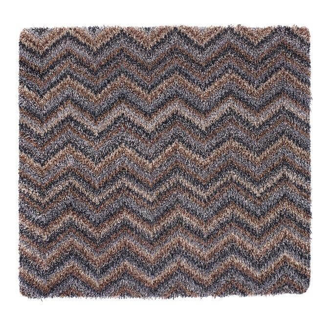 A plush shaggy area rug with a washable chevron design in shades of brown and gray