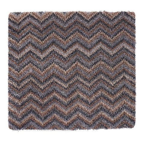 A plush shaggy area rug with a washable chevron design in shades of brown and gray