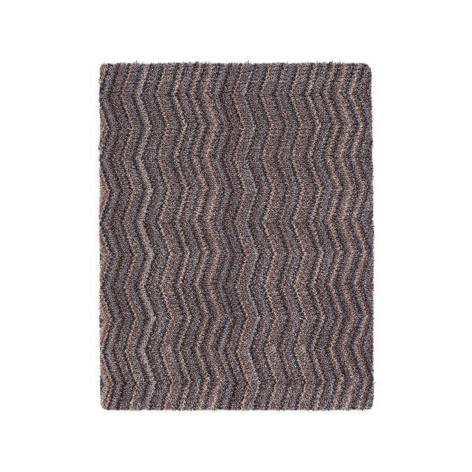 A rectangular washable mat with a bold gray and brown chevron design and textured surface