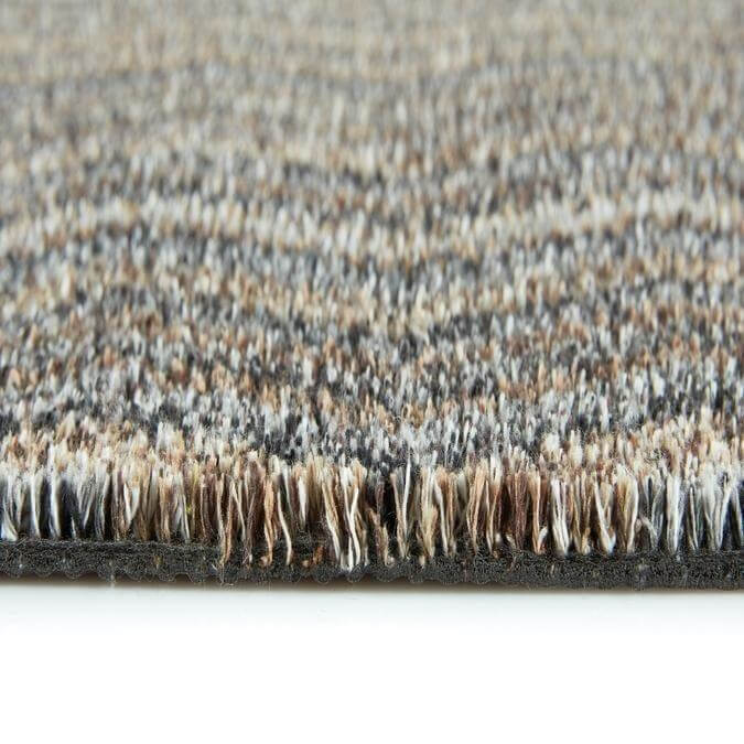 Beige and gray washable mats with a plush woven fiber surface featuring a chevron design pattern
