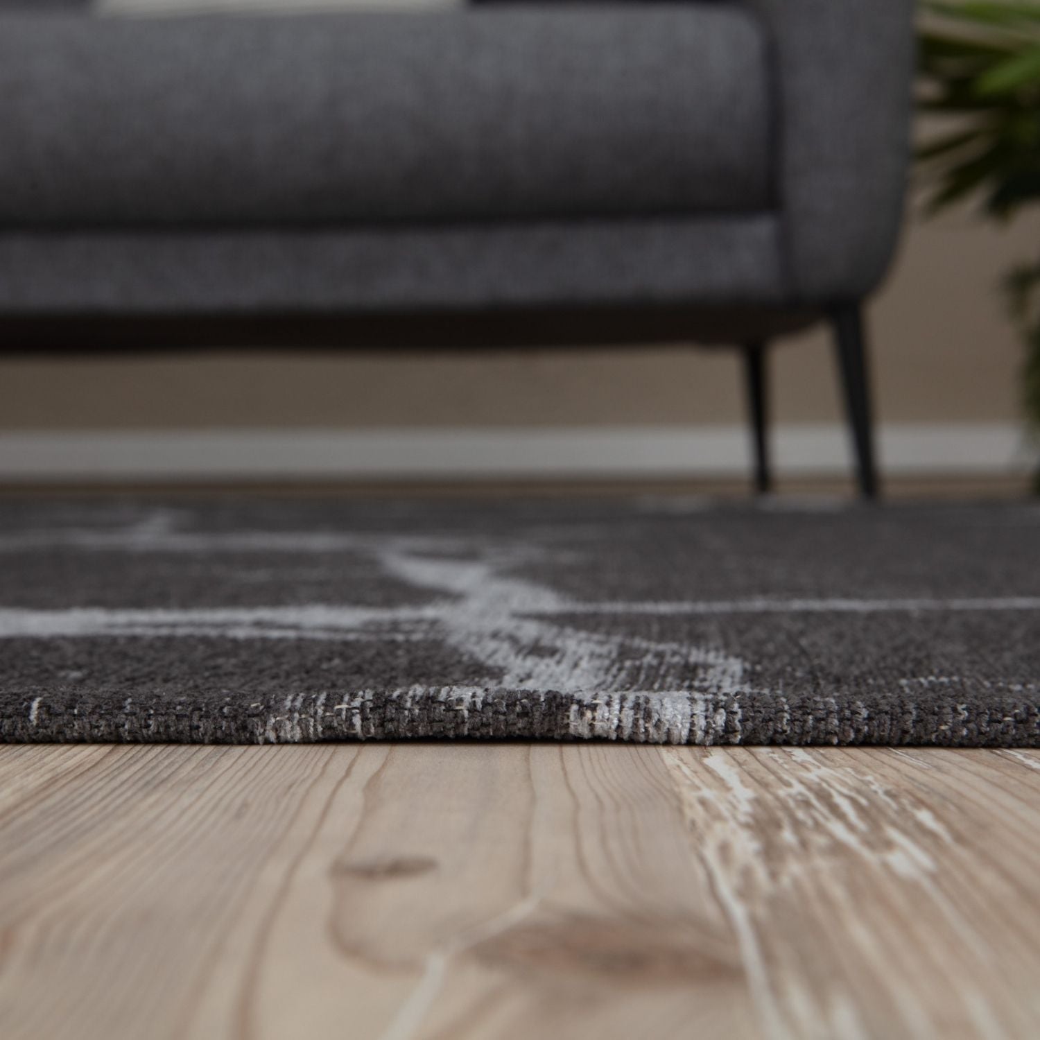 Dark grey washable rug carina with subtle white abstract pattern and textured woven edge perfect for easy care spaces