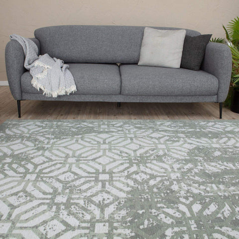 Gray textured sofa with black legs and decorative pillows shown with washable carina green rug for a cozy space