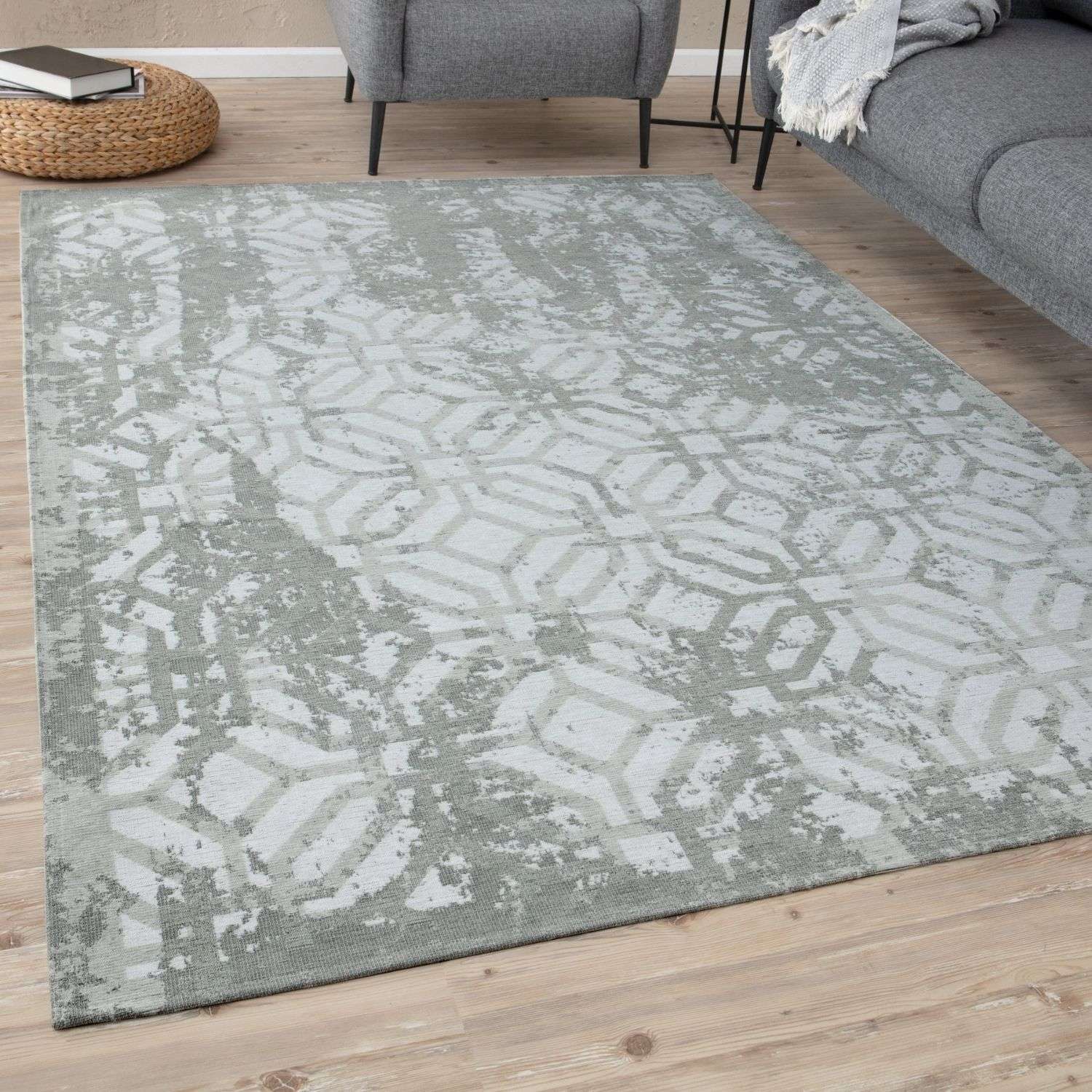 A washable rectangular rug carina green with a faded geometric gray and white pattern perfect for any room