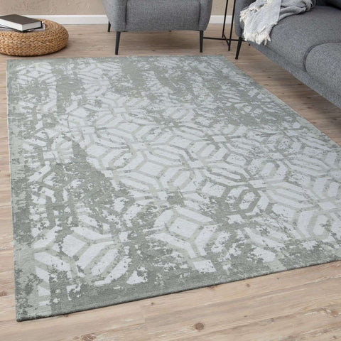 A washable rectangular rug carina green with a faded geometric gray and white pattern perfect for any room