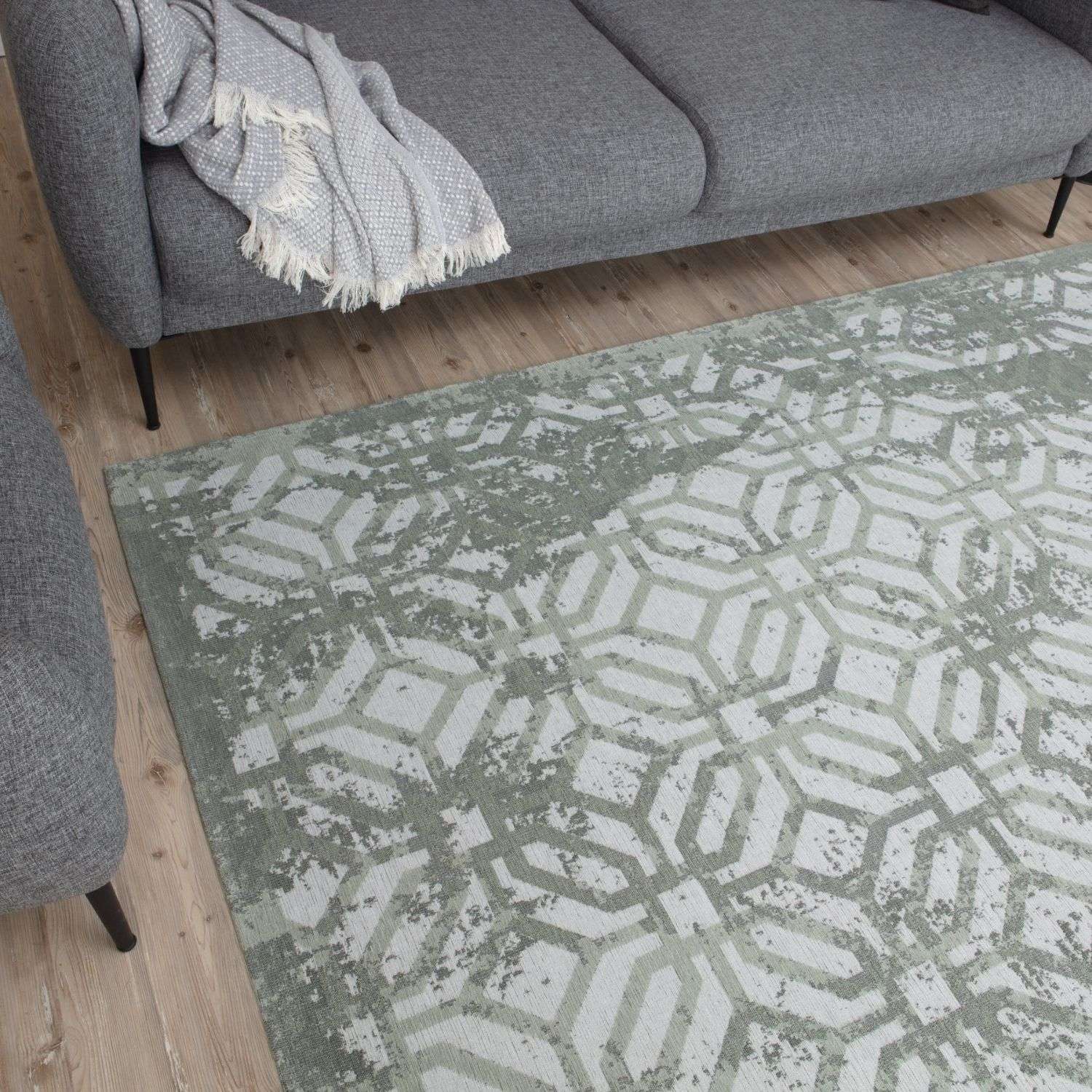 Rectangular washable rug carina green with a muted sage green and off-white geometric hexagonal pattern green rug