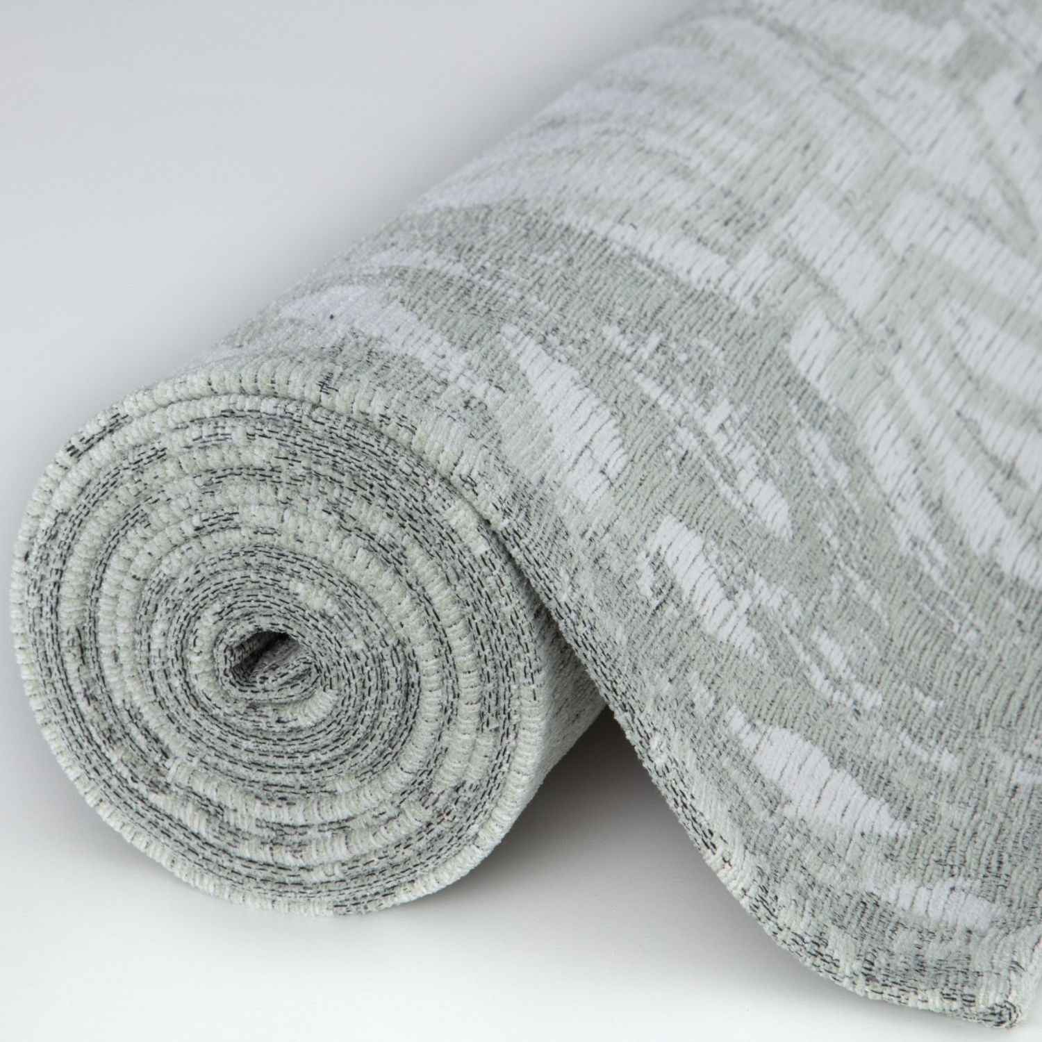 Rolled-up washable rug carina green with gray and white textured abstract pattern perfect green rug choice