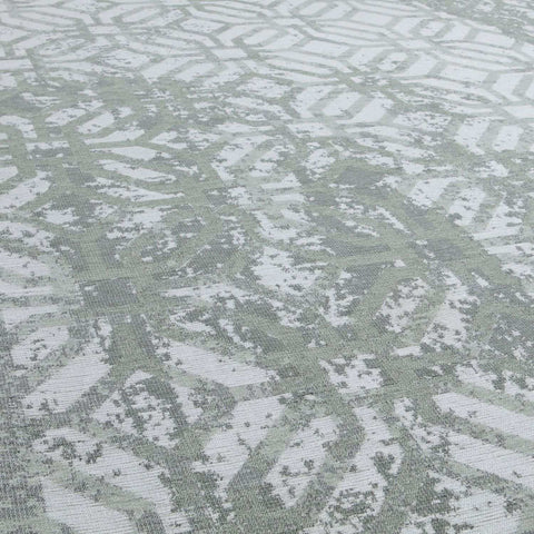 Textured washable rug carina green with faded geometric pattern in muted sage green and white green rug