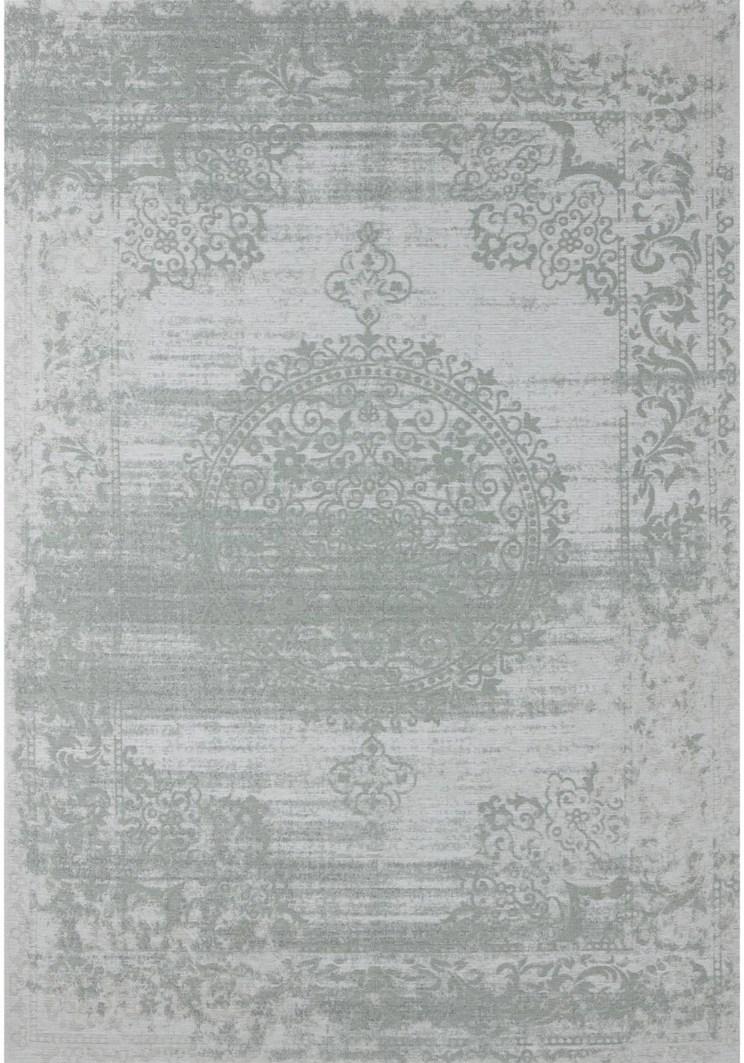 A vintage inspired washable rug carina green with a faded distressed pattern in muted sage green and off white tones