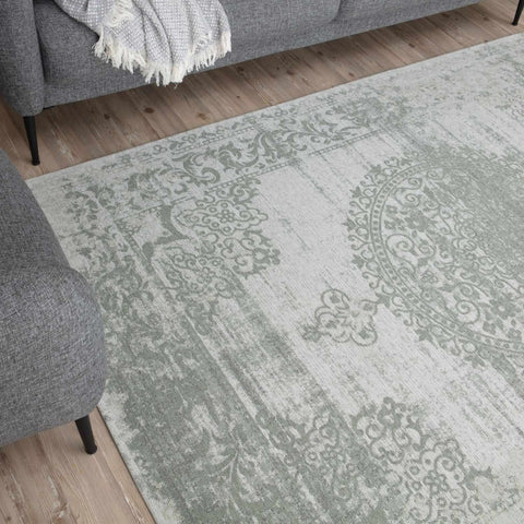Rectangular washable rug carina green with faded vintage damask pattern in muted sage green and off-white tones