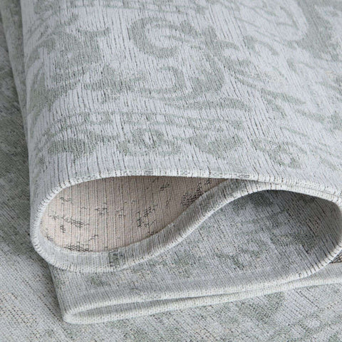 A soft gray washble rug carina green with subtle textured and woven pattern perfect as a green rug option