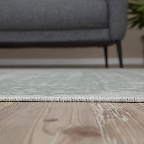 A soft washable green rug carina green with a subtle textured pattern and white fringe perfect for any room