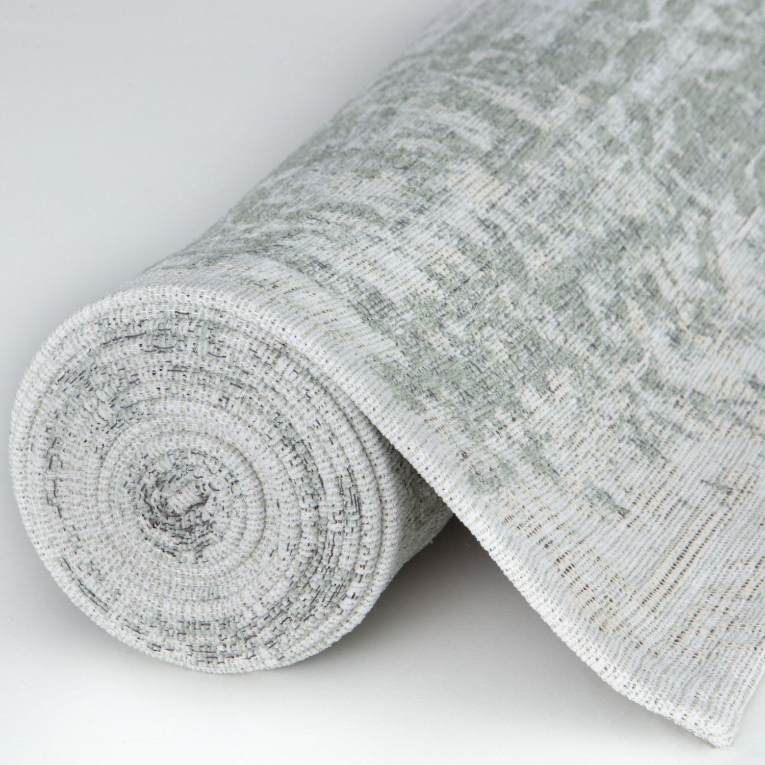 A soft textured gray and white woven fabric roll for washable carina green rug with subtle pattern and green rug style