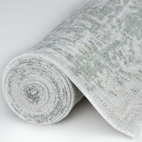 A soft textured gray and white woven fabric roll for washable carina green rug with subtle pattern and green rug style