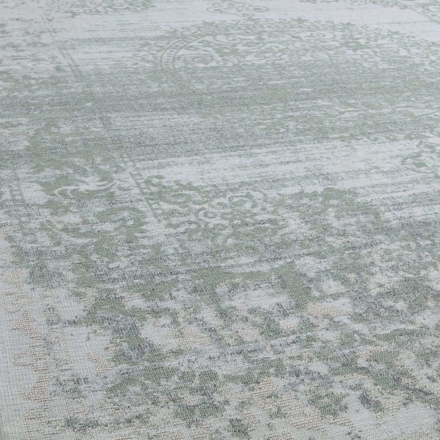 Vintage-style washable rug carina green with faded distressed pattern in muted sage green and off-white tones