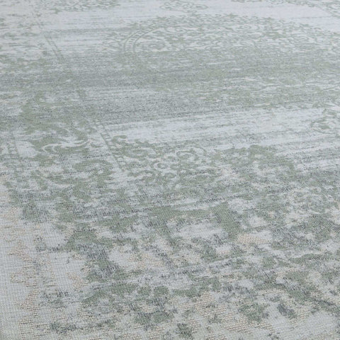 Vintage-style washable rug carina green with faded distressed pattern in muted sage green and off-white tones