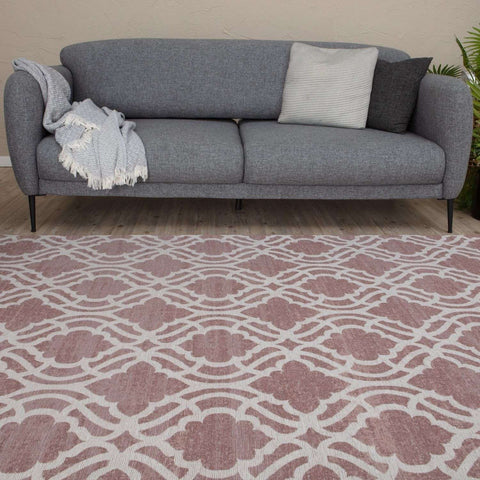 Gray textured sofa with black legs and two throw pillows shown next to washable rug carina pink 6902p