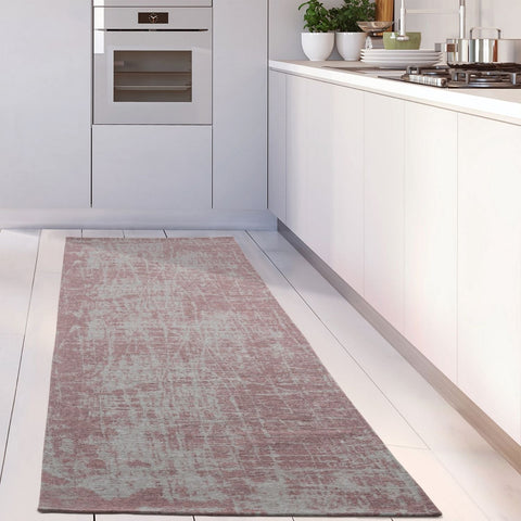 A soft washable rug carina in pink with gray texture and subtle distressed pattern on kitchen floor runner