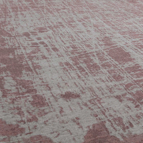 A soft pink and gray textured woven washable rug carina perfect for stylish easy-care spaces