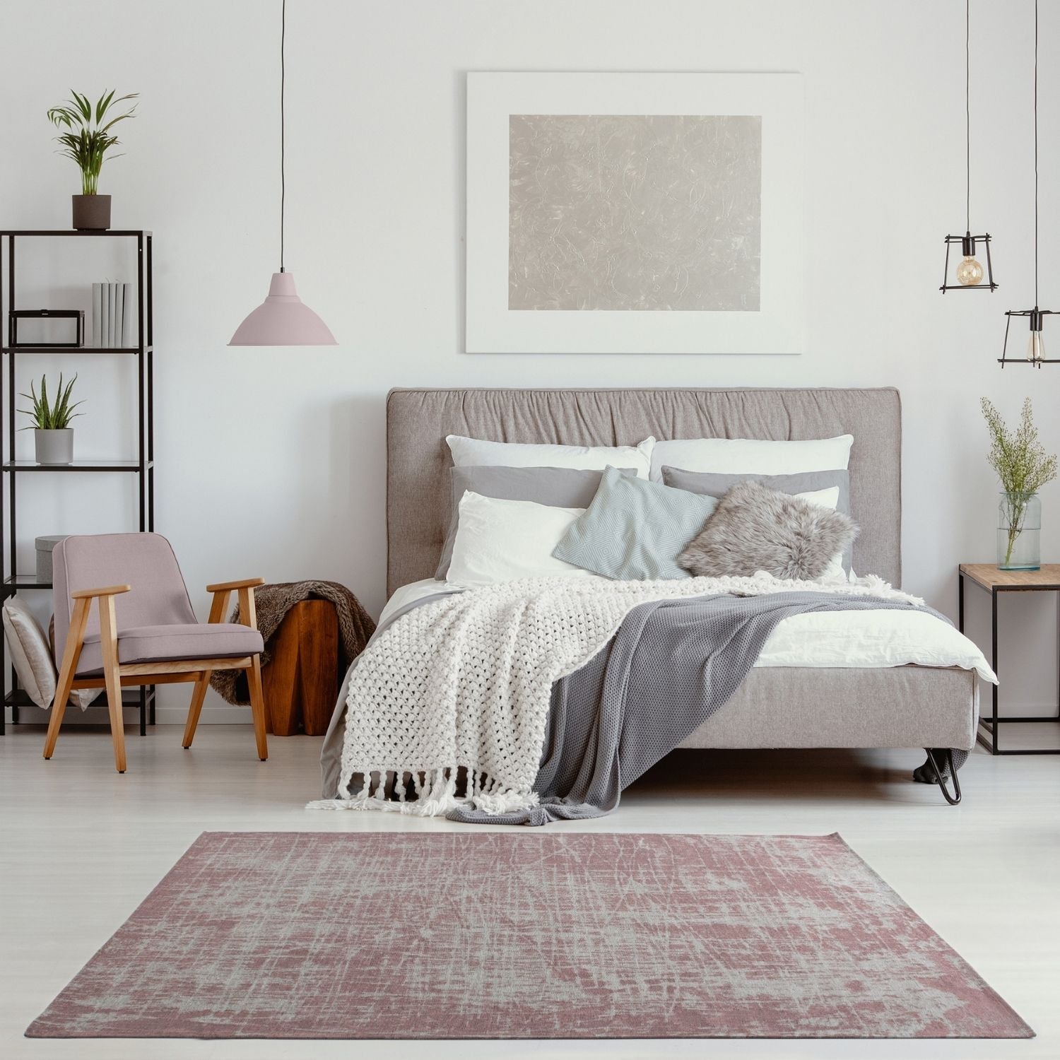 A soft mauve washable rug carina pink with a distressed textured pattern lies centered in the room