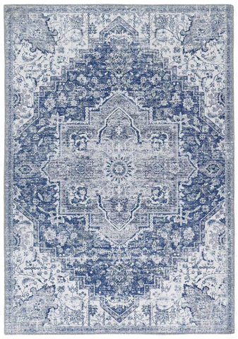 A vintage-inspired washable rug eterna blue with intricate blue and gray floral and geometric patterns