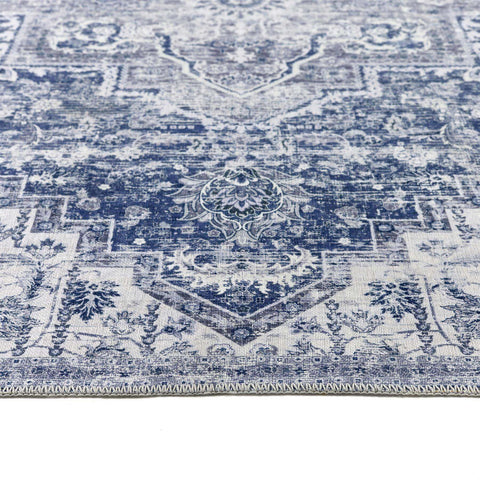Vintage-inspired eterna blue washable rug with faded blue and cream floral and geometric patterns