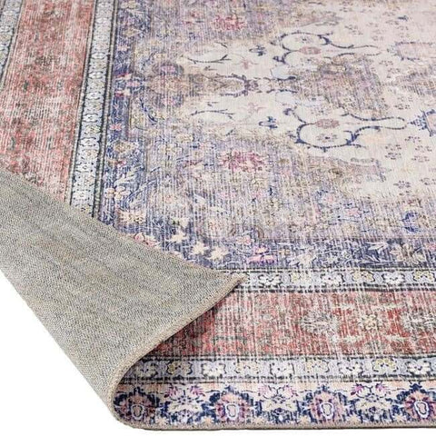 Vintage-style washable rug with faded pink blue cream floral patterns on woven wool featuring eterna medallion design