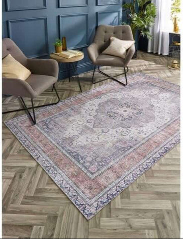 Vintage-style washable rug with eterna medallion design in faded purples and pinks with a distressed pattern