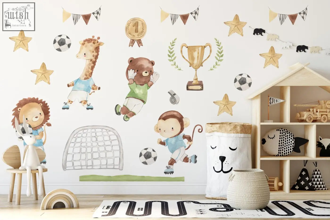 White fabric storage bin with smiling dog face and brown woven lid next to watercolor football animals wall decals including lion playing soccer
