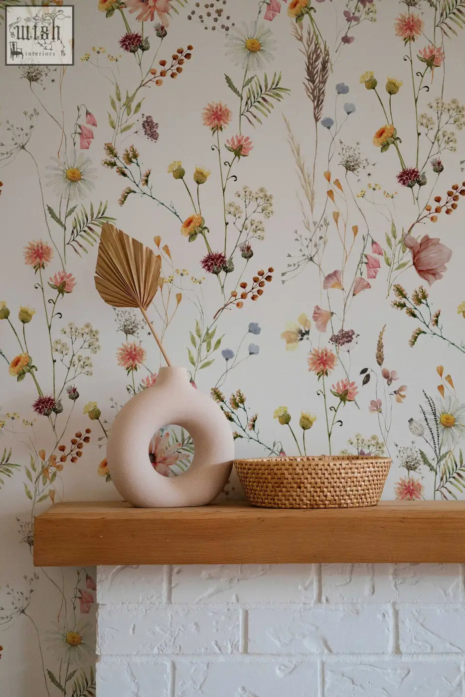 Cream-colored ceramic vase with circular cutout complements soft botanical field floral wallpaper for living space contact clickwalls