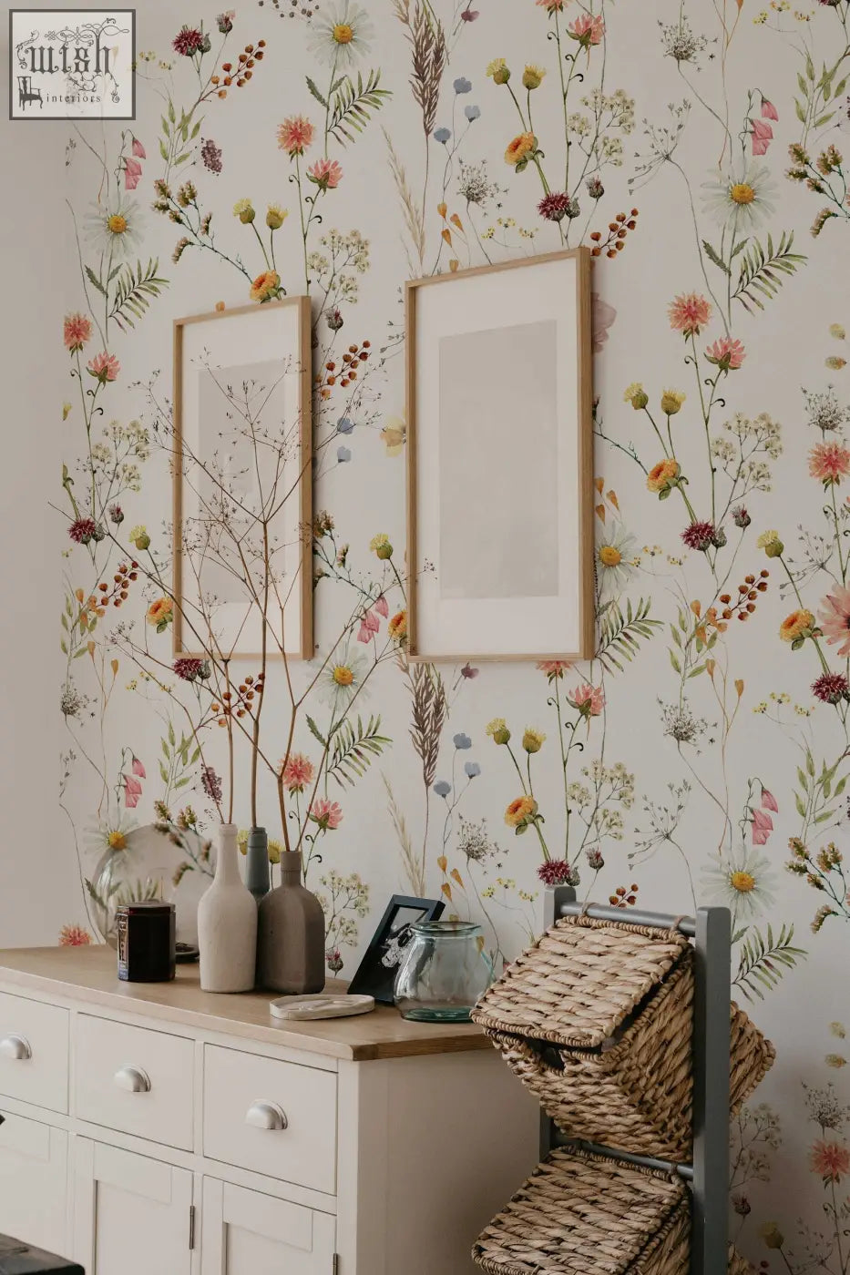 Woven wicker storage baskets with metal frame complement living space with soft botanical field floral wallpaper by clickwalls