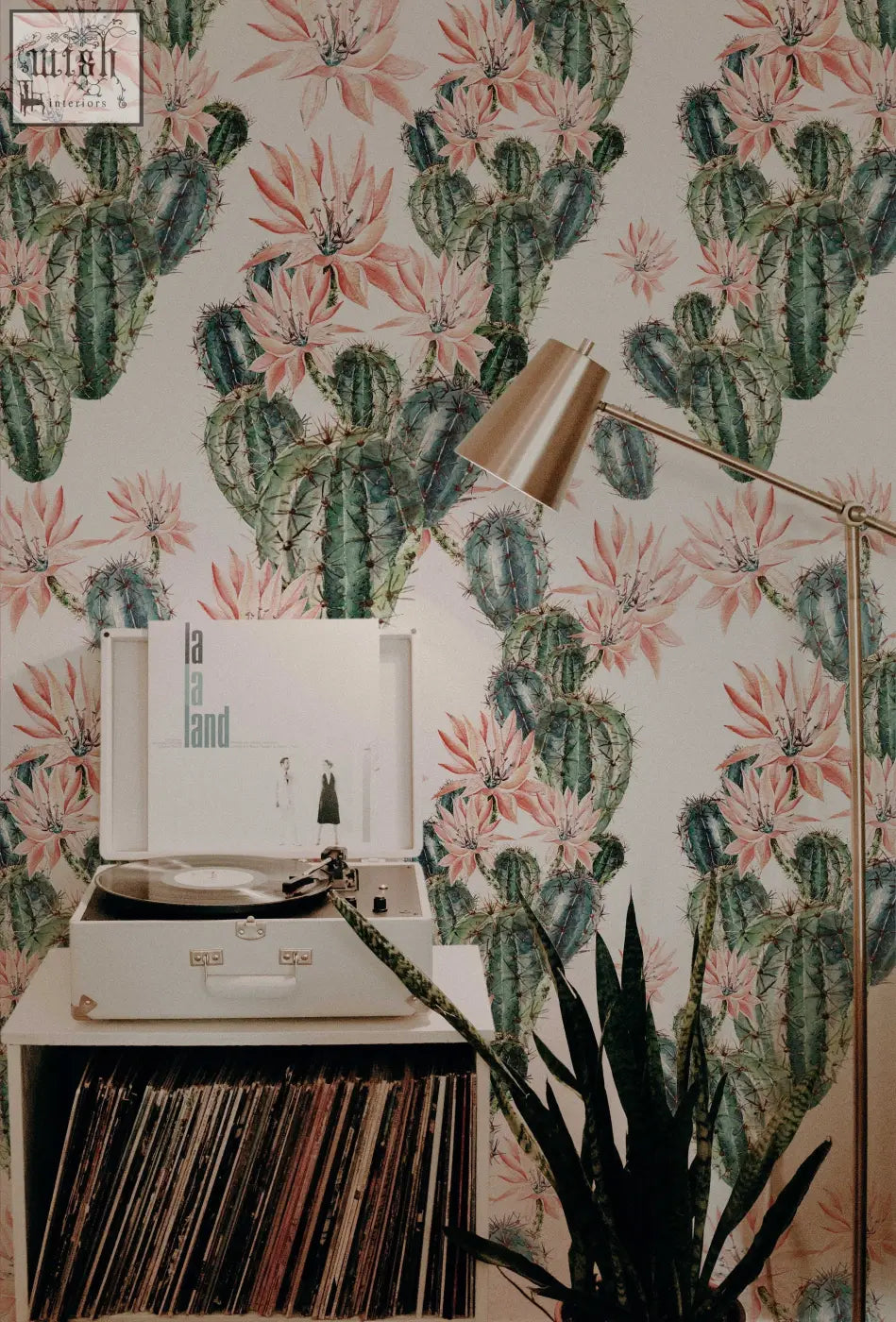 White vintage-style record player with silver turntable on a white shelf in living space with contact clickwalls traditional paper