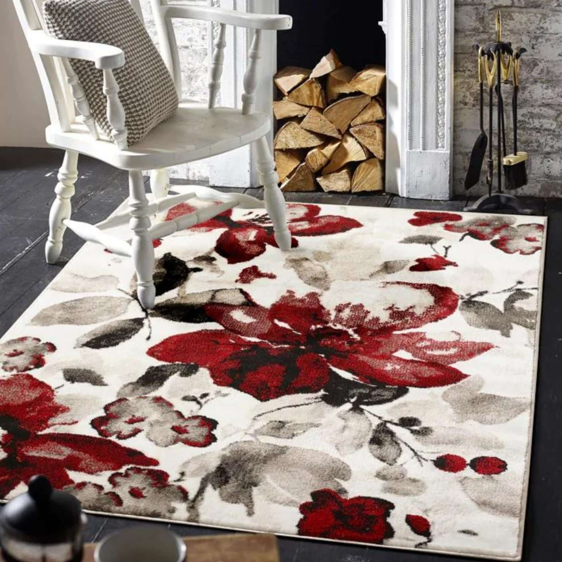 A rectangular floral design rug with bold red black and gray watercolour floral pattern on off-white background