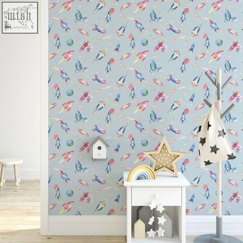 A charming white wooden nightstand with star decorations and a golden star lamp pairs perfectly with hand-painted space wallpaper