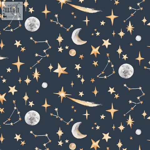 A navy blue fabric with a watercolor-style pattern of glowing stars moons and constellations perfect for night sky decor