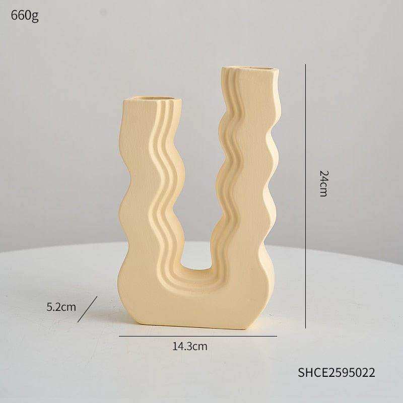 Cream-colored ceramic wavy wonder vase with u-shaped design and two vertical openings for decoration